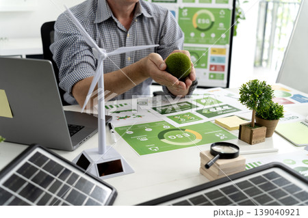 Business professional planning ESG sustainable development strategy renewable energy solutions green technology investment working in modern office environment Business professional planning ESG sustainable development strategy renewable energy solutions green technology investment working in modern office environment 139040921