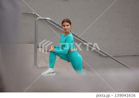 Workout On Stairs. Girl In Fitness Outfit Warming Up Before Intensive Exercising. Fashion Sporty Woman Training Outdoors On Stadium. Workout On Stairs. Girl In Fitness Outfit Warming Up Before Intensive Exercising. Fashion Sporty Woman Training Outdoors On Stadium. 139041616