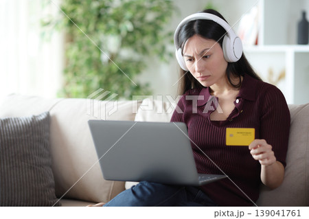 Suspicious asian woman trobled buying online at home 139041761