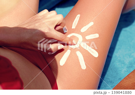 Closeup female leg with sun shape. Sun protection sun cream, on her smooth tanned legs. Sunblock. Skincare. Closeup female leg with sun shape. Sun protection sun cream, on her smooth tanned legs. Sunblock. Skincare. 139041880