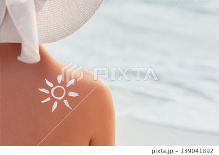 Woman With Suntan Lotion At The Beach In Form Of The Sun. Portrait Of Female With the Drawn Sun On a Shoulder On The Pool Woman With Suntan Lotion At The Beach In Form Of The Sun. Portrait Of Female With the Drawn Sun On a Shoulder On The Pool 139041892