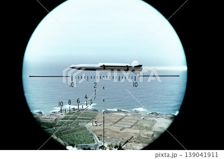 Military missile under targeting scope against ocean and coastal background Military missile under targeting scope against ocean and coastal background 139041911