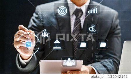 A businessman in a suit interacts with a futuristic digital interface featuring AI, data management, and growth icons to optimize business performance and strategy A businessman in a suit interacts with a futuristic digital interface featuring AI, data management, and growth icons to optimize business performance and strategy 139042141