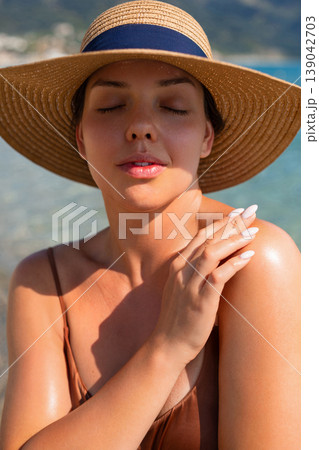Beautiful Woman Touching Shoulder And Face At Beach. Beauty Skincare Routine. Female Enjoying Sunlight And Summer Vacation Lifestyle 139042703