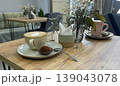 cup of coffee and cake on the table in cafe 139043078