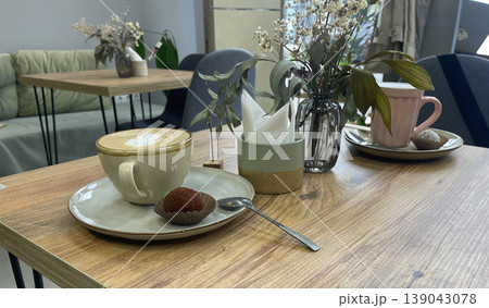 cup of coffee and cake on the table in cafe 139043078