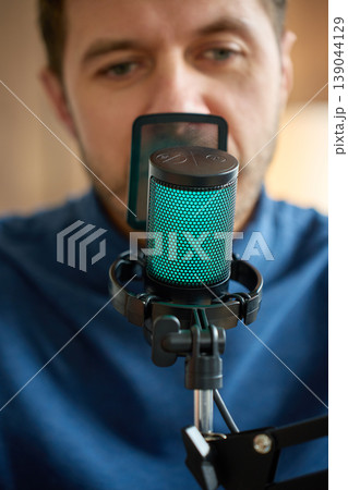 Close up of man speaking in podcast microphone in home studio Close up of man speaking in podcast microphone in home studio 139044129