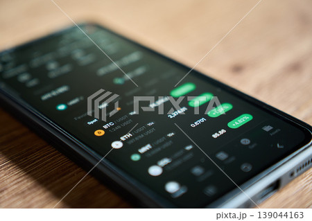 Mobile phone with crypto market prices on trading app 139044163