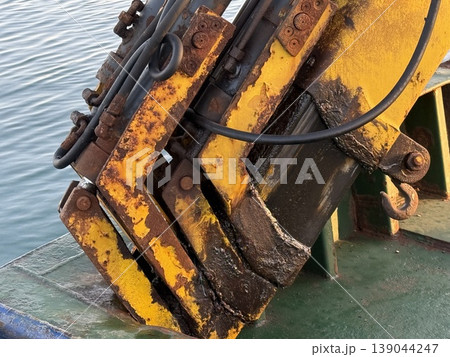 Industrial machinery detail with rust on yellow metal in closeup, suitable as textured background 139044247