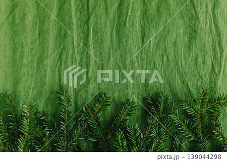 Fresh spruce branches on a green craft paper background. Fresh spruce branches on a green craft paper background. 139044298