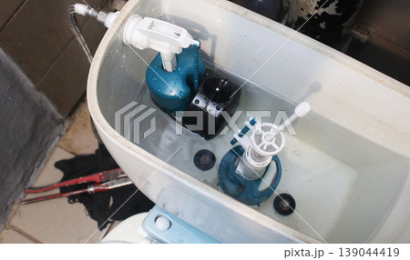 Installed toilet tank flush mechanism Installed toilet tank flush mechanism 139044419