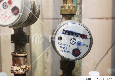 Cold water meter on the pipe. Close-up Cold water meter on the pipe. Close-up 139044427