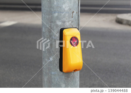 Green traffic light call button at a pedestrian crossing Green traffic light call button at a pedestrian crossing 139044488