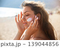 Pretty Woman Relaxing With Closed Eyes And Sunscreen On Face At Beach. Beauty Skincare And Sun Protection Concept 139044856