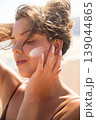 Beautiful Woman With Closed Eyes And Sunscreen On Face At Beach. Beauty Skincare And Sun Protection Concept 139044865