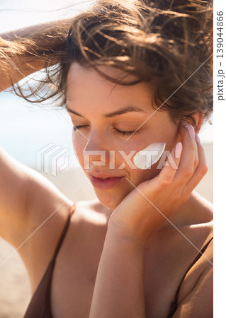 Pretty Woman Touching Face With Sunscreen On Skin At Beach Close Up. Beauty Skincare And Sun Protection Concept 139044866