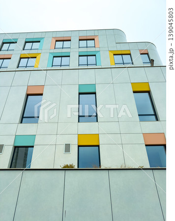 Modern building with colorful windows in urban area captured during daytime 139045803