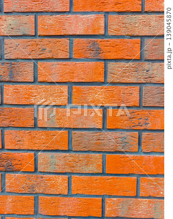 Brick wall pattern with rich colors in a close view showcasing various shades and textures, captured during daylight 139045870