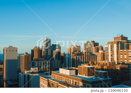 City skyline view showing buildings and structures during daylight hours with clear blue sky in the background City skyline view showing buildings and structures during daylight hours with clear blue sky in the background 139046130