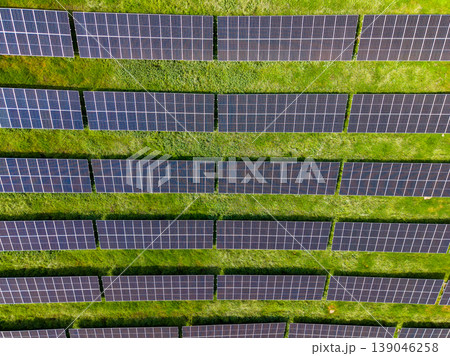 Solar panels cover a large field in a renewable energy project under bright sunlight in the afternoon Solar panels cover a large field in a renewable energy project under bright sunlight in the afternoon 139046258