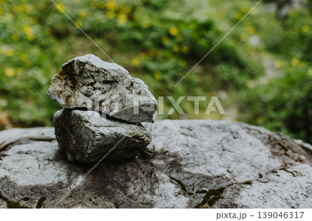 Two stones one in on top of the other on a natural background. 139046317