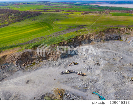 Granite quarry activity showing machinery and landscape in a rural area during daylight hours 139046358