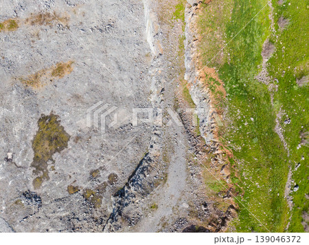 Granite quarry shows mining activity and natural landscape in the background during daytime 139046372