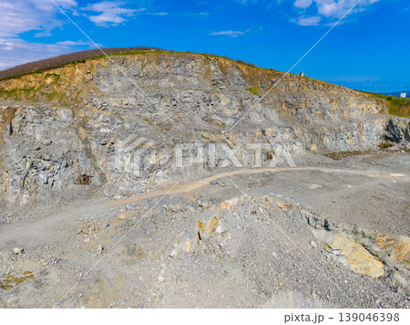 Granite quarry located in a rural area with rock formations and clear blue sky during daylight hours Granite quarry located in a rural area with rock formations and clear blue sky during daylight hours 139046398