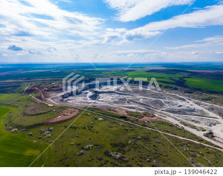 Granite quarry located in a rural area with visible land use changes and machinery during a sunny day 139046422
