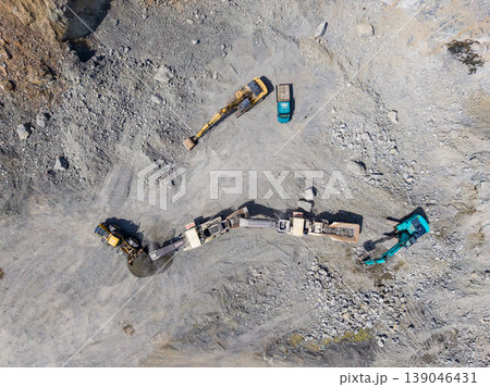 Granite quarry operation with heavy machinery and equipment at work in a mining site showing extraction activity from above 139046431