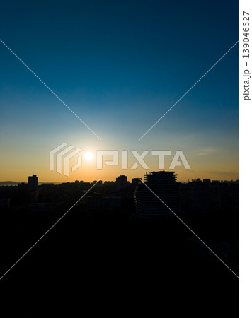 Sunrise over the city skyline with buildings in silhouette in the early morning hours Sunrise over the city skyline with buildings in silhouette in the early morning hours 139046527