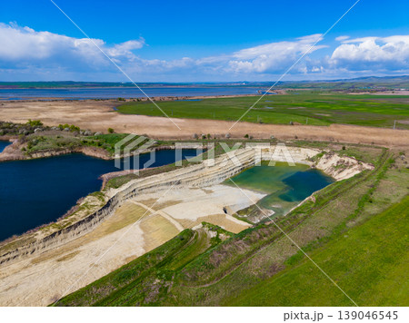 View of a large empty area with water bodies and dry land near a coastline on a sunny day 139046545