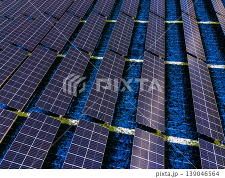Solar panels cover large area on a rooftop in a city with clear weather, showcasing renewable energy use during daytime hours for energy generation Solar panels cover large area on a rooftop in a city with clear weather, showcasing renewable energy use during daytime hours for energy generation 139046564