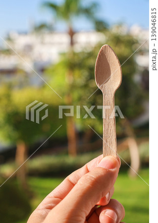 A small eco-friendly wooden spoon in a person's hand A small eco-friendly wooden spoon in a person's hand 139046815