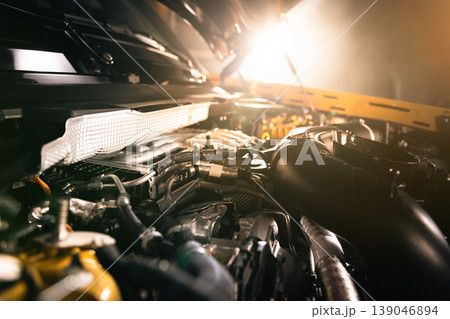 Open modern diesel car engine under hood with dramatic lighting. Automotive engineering, powertrain detail and professional service concept. 139046894