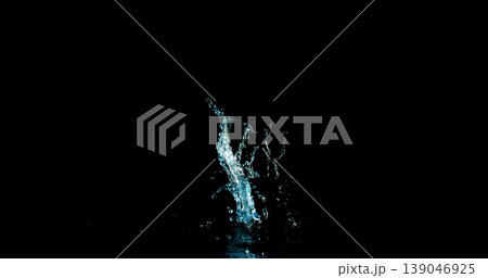 High-speed water splash isolated on black background, dynamic liquid shape frozen mid-air with fine droplets. Minimal composition ideal for VFX overlay and creative compositing. 139046925