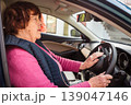 Senior Caucasian woman learns driving with professional instructor inside a training car. She develops new skills and confidence. Concept of education and equal opportunities for elderly people. 139047146