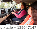 Mature Caucasian woman attends driving class with professional trainer. She improves coordination and attention. Concept of cognitive activity, education, and healthy aging. 139047147