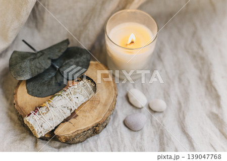 White sage and candle with stones for meditation. Minimalism. Calm and mindfulness. White sage and candle with stones for meditation. Minimalism. Calm and mindfulness. 139047768