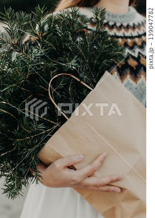 Bouquet of spruce branches with Christmas lights in a female hands. Bouquet of spruce branches with Christmas lights in a female hands. 139047782