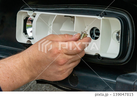 Close up of automotive light bulb replacement Close up of automotive light bulb replacement 139047815