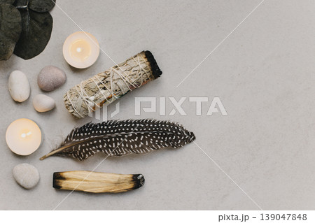 Palo santo, white sage and candle with stones for meditation. Minimalism. Calm and mindfulness. Palo santo, white sage and candle with stones for meditation. Minimalism. Calm and mindfulness. 139047848