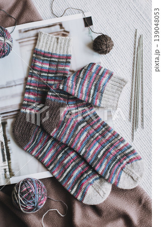 Hand knitted socks with needles and yarn ball. Concept for handmade and hygge slow life. Hand knitted socks with needles and yarn ball. Concept for handmade and hygge slow life. 139048053