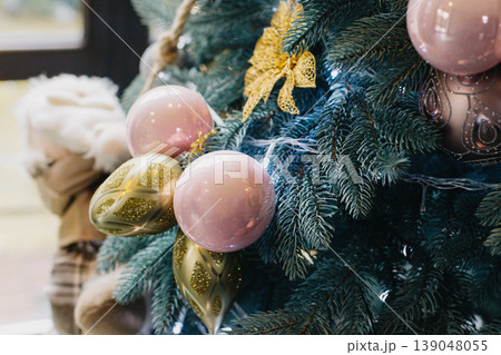 Spruce branches with Christmas ornaments and lights. 139048055