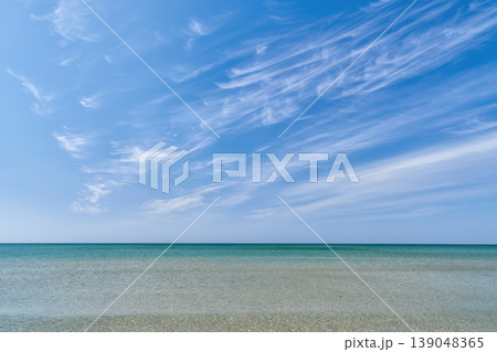 seascape of a calm, clear sea, a poster advertising a seaside vacation and a relaxing beach holiday, copy space for text seascape of a calm, clear sea, a poster advertising a seaside vacation and a relaxing beach holiday, copy space for text 139048365
