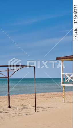 Empty beaches and preparations for the summer season and the influx of tourists, vacation on the Mediterranean Sea, vertical photo with a frame for tented 139048371