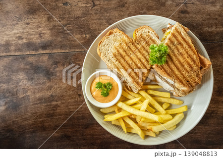 Grilled sandwiches with melted cheese on a wooden rustic board 139048813