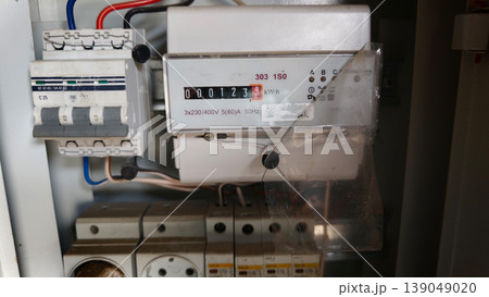 Electric meter measures energy use at a residential building in the city 139049020