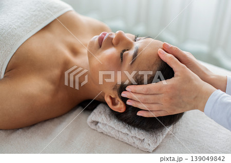 Close up of African American woman receiving head massage at spa 139049842