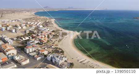 Aerial view of Sal Rei town sandy beach and yacht moored in the shore Aerial view of Sal Rei town sandy beach and yacht moored in the shore 139050110